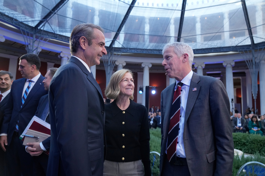 Greece's Prime Minister Kyriakos Mitsotakis, left, speak with Chris Wright, Secretary of the U.S. Department of Energy, right during the Atlantic Council conference, in Athens, Greece, Friday, Nov. 7, 2025. (AP Photo/Petros Giannakouris)