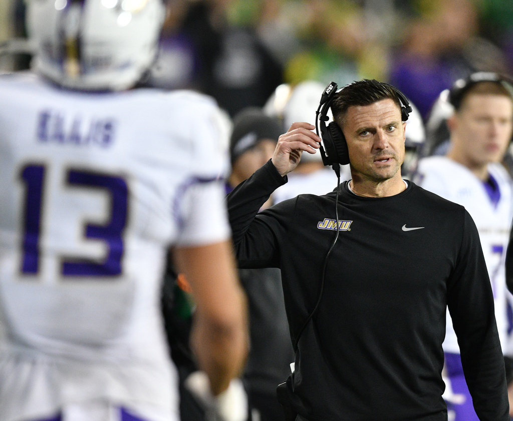 James Madison head coach Bob Chesney talks to wide receiver Landon Ellis (13) after a pass play against Oregon during the first half in the first round of the NCAA College Football Playoff, Saturday, Dec. 20, 2025, in Eugene, Ore. (AP Photo/Mark Ylen)