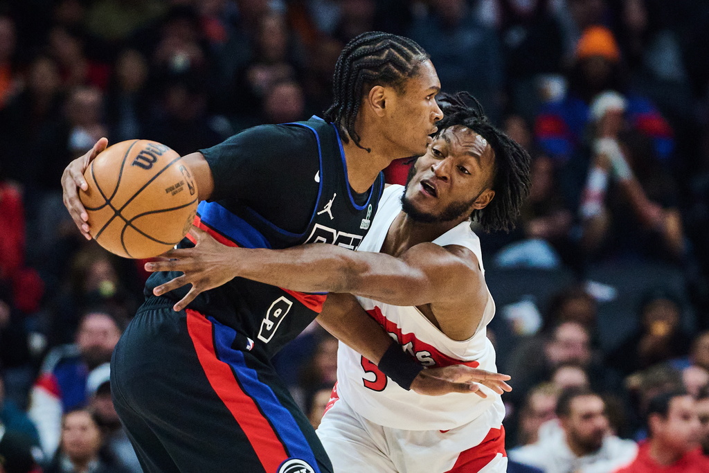 Toronto Raptors' Immanuel Quickley (5) defends against Detroit Pistons' Ausar Thompson (9) during the first half of an NBA basketball game in Toronto, Wednesday, Feb. 11, 2026. (Sammy Kogan/The Canadian Press via AP)