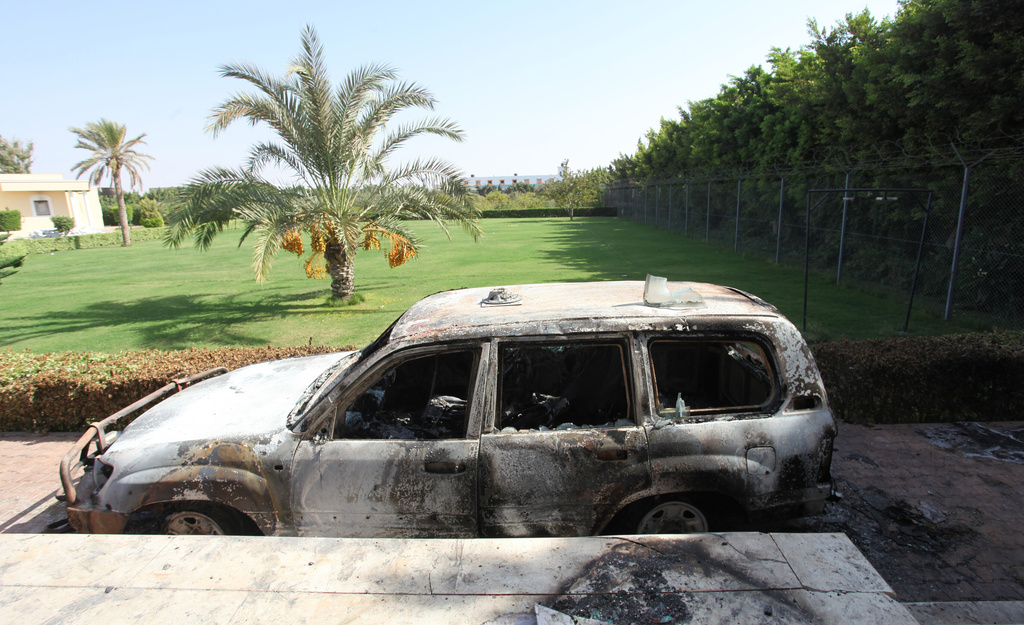FILE - A burnt car sits in front of the U.S. consulate on Sept. 13, 2012, after an attack that killed four Americans, including Ambassador Chris Stevens, on the night of Sept. 11, in Benghazi, Libya. (AP Photo/Mohammad Hannon, File)