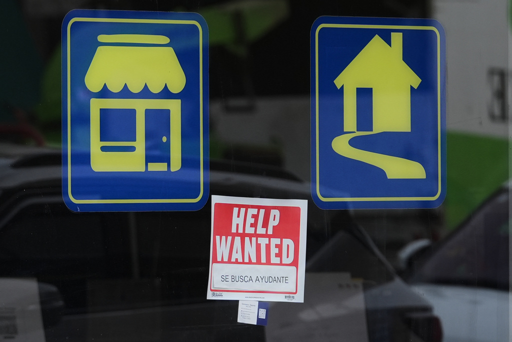 Help wanted sign is displayed at a store in Chicago, Wednesday, March 25, 2026. (AP Photo/Nam Y. Huh)