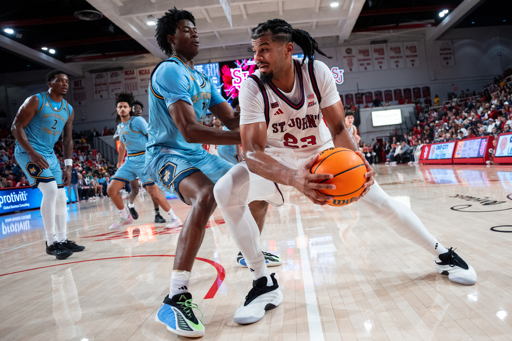 St. John's forward Bryce Hopkins (23), defended by Quinnipiac forward Keith McKnight (21) heads toward the basket during the second half of an NCAA college basketball game, Monday, Nov. 3, 2025, in New York. (AP Photo/Angelina Katsanis)