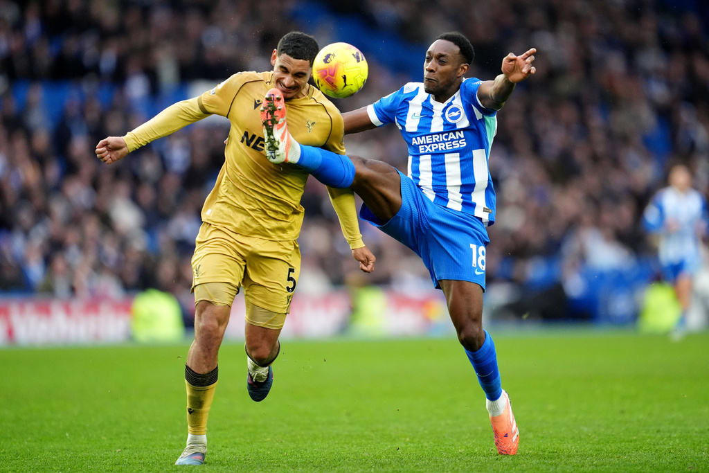 Brighton and Hove Albion's Danny Welbeck, right, and Crystal Palace's Maxence Lacroix in action during their English Premier League soccer match in Brighton, England, Sunday, Feb. 8, 2026. (Adam Davy/PA via AP)