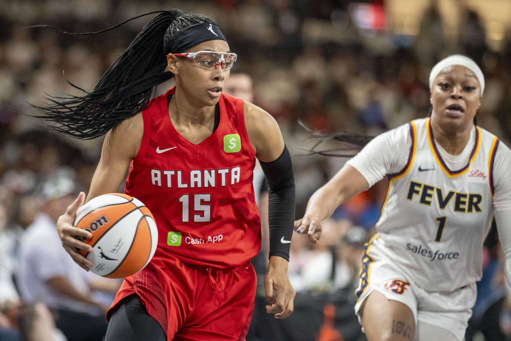 Atlanta Dream guard Allisha Gray, left, drives the ball during the first half of Game 1 against the Indiana Fever in the first round of the WNBA basketball playoffs Sunday, Sept. 14, 2025, in Atlanta. (AP Photo/Erik Rank)