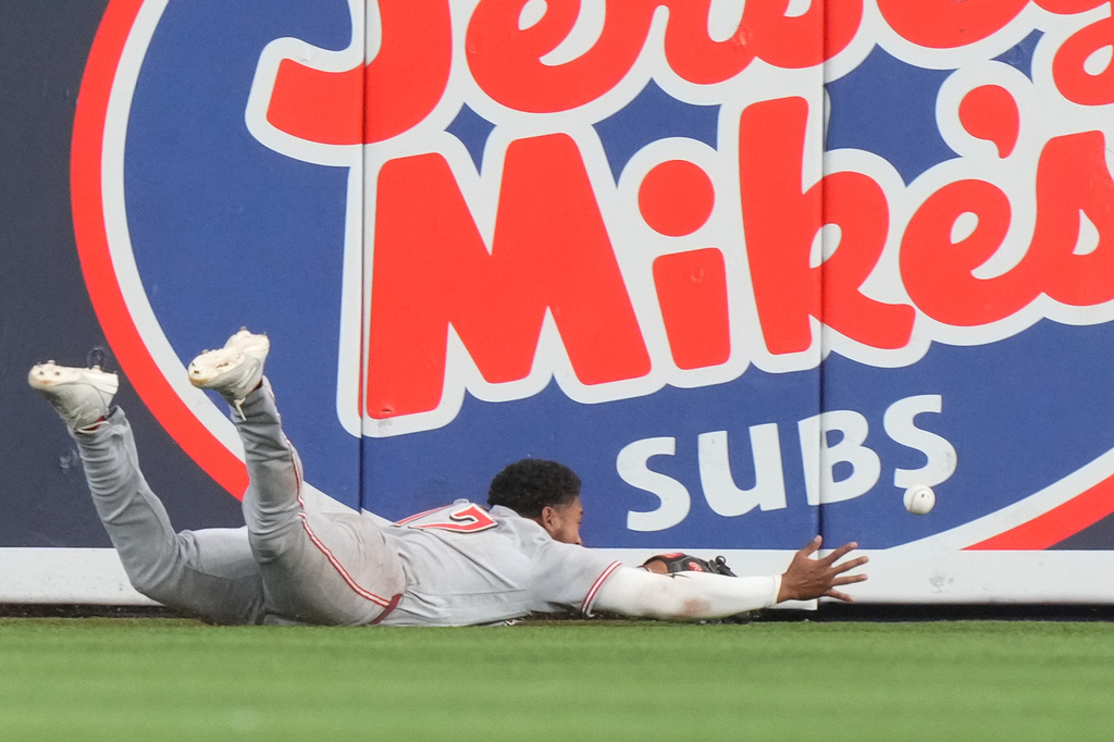 Cincinnati Reds center fielder Dane Myers (17) is unable to catch a hit by Miami Marlins Xavier Edwards during the first inning of baseball game Thursday, April 9, 2026, in Miami. (AP Photo/Marta Lavandier)