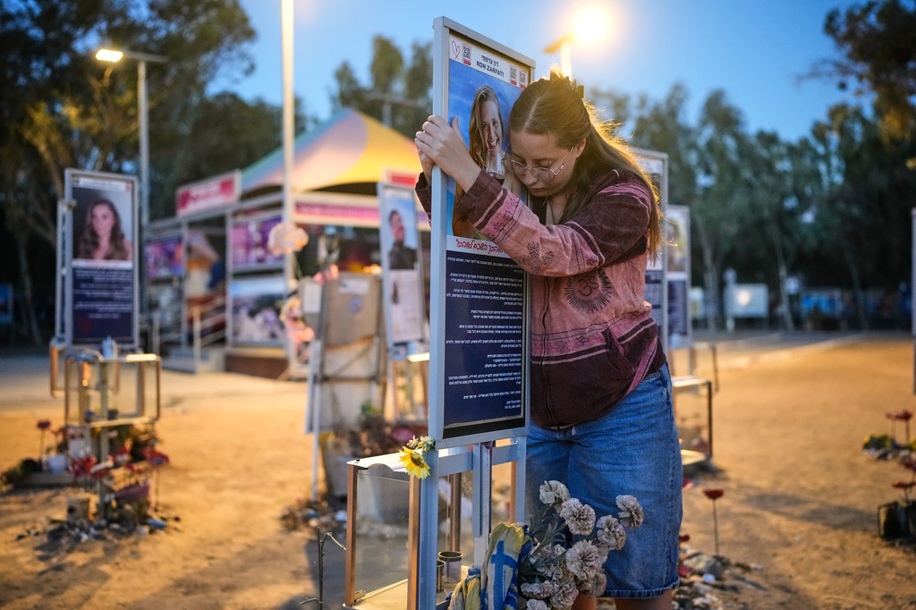 Raz Zarfati, sister of Ron Zarfati who was killed in the Oct. 7, 2023, Hamas attack on Israel, attend a memorial marking the third anniversary of the attack at the Nova music festival site near Kibbutz Reim, southern Israel, Wednesday, Oct. 7, 2026. (AP Photo/Ohad Zwigenberg)