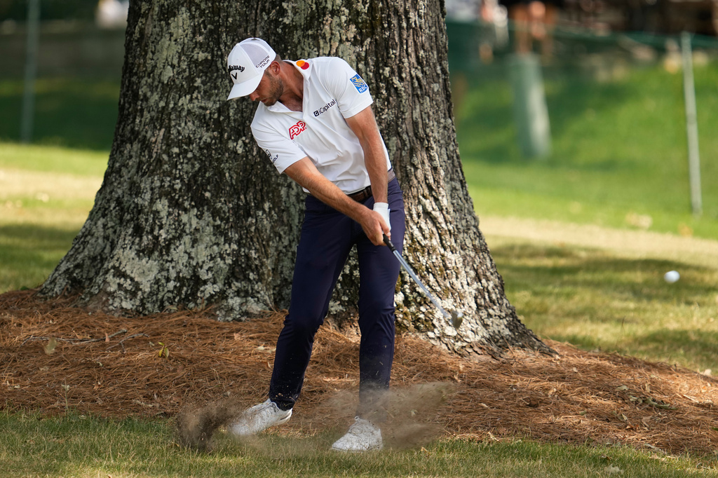 Sam Burns hits from the rough on the 17th hole during the third round of the St. Jude Championship golf tournament Saturday, Aug. 15, 2026, in Memphis, Tenn. (AP Photo/George Walker IV)