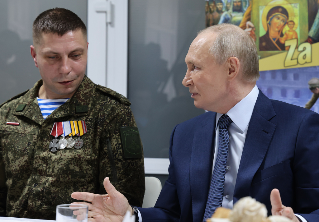 Russian President Vladimir Putin, right, talks with Russian servicemen who fought in Ukraine as he visits the Central Military Clinical Hospital, in Moscow, Russia, Wednesday, Oct. 29, 2025. (Vladimir Gerdo, Sputnik, Kremlin Pool Photo via AP)