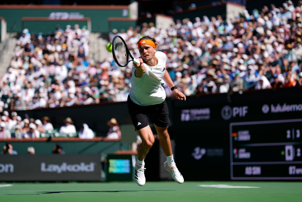 Alexander Zverev, of Germany, returns a shot against Jannik Sinner, of Italy, during a semifinal match at the BNP Paribas Open tennis tournament, Saturday, March 14, 2026, in Indian Wells, Calif. (AP Photo/Mark J. Terrill)