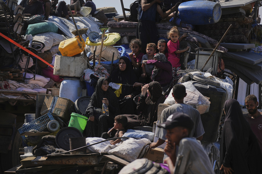 Displaced Palestinians flee Gaza City by foot and vehicles, carrying their belongings along the coastal road toward southern Gaza, Wednesday, Sept. 17, 2025. (AP Photo/Abdel Kareem Hana)