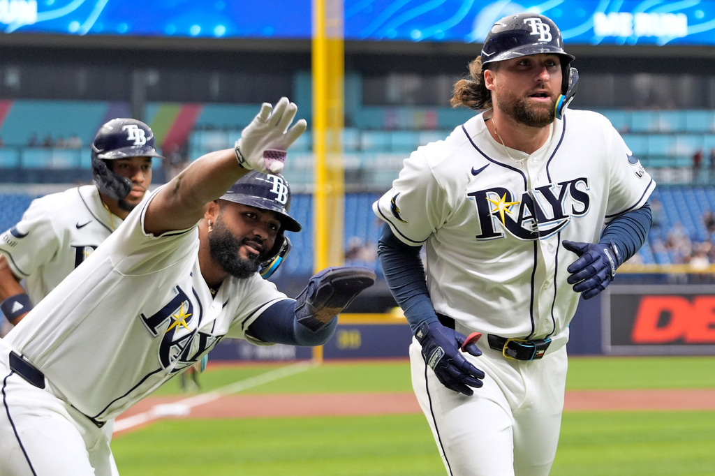 Tampa Bay Rays' Ryan Vilade, right, celebrates his three-run home run off Toronto Blue Jays pitcher Eric Lauer with Junior Caminero, center, and Chandler Simpson, left, during the first inning of a baseball game Monday, May 4, 2026, in St. Petersburg, Fla. (AP Photo/Chris O'Meara)