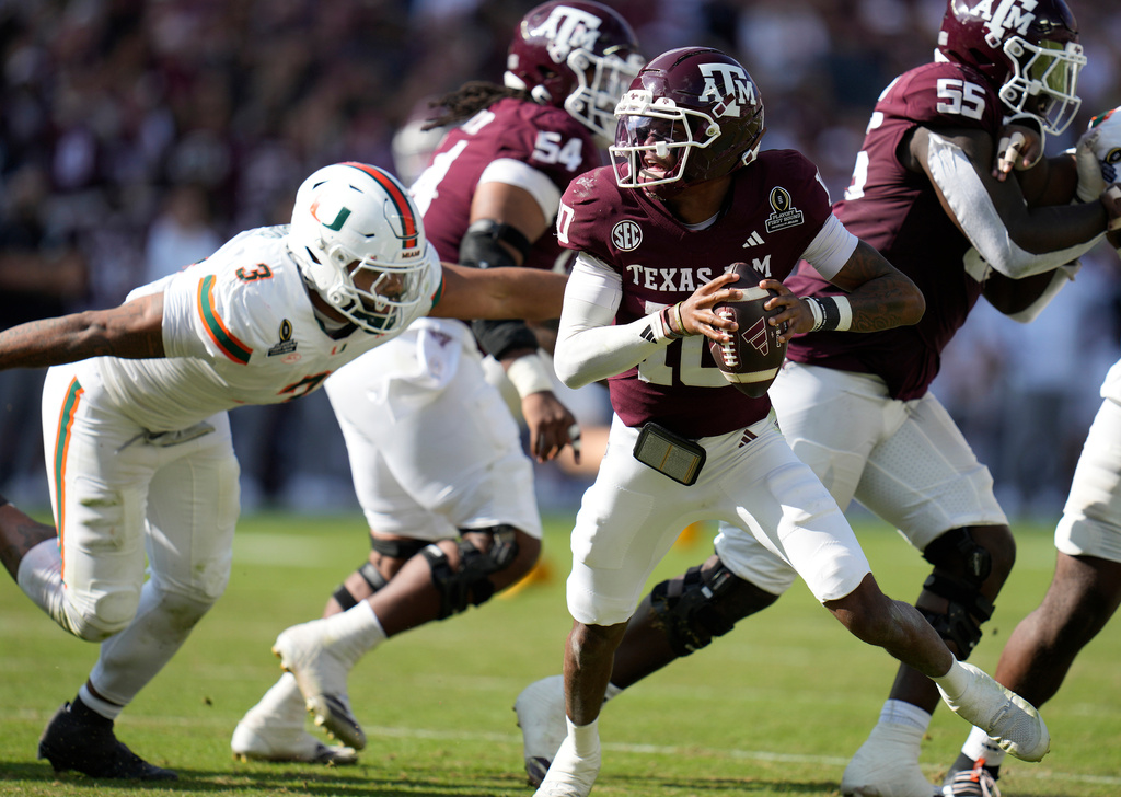 Texas A&M quarterback Marcel Reed (10) scrambles before being sacked by Miami defensive lineman Akheem Mesidor, left, during the second half of the first round of the NCAA College Football Playoff, Saturday, Dec. 20, 2025, in College Station, Texas. (AP Photo/Karen Warren)