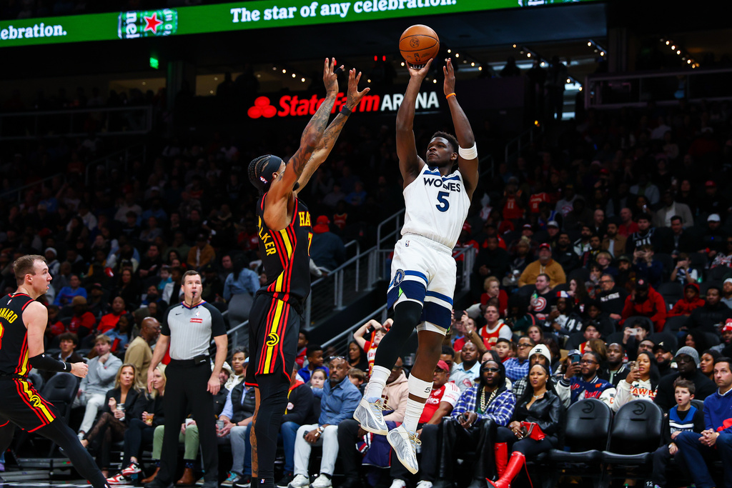 Minnesota Timberwolves guard Anthony Edwards (5) shoots over Atlanta Hawks guard Nickeil Alexander-Walker during the first half of an NBA basketball game, Wednesday, Dec. 31, 2025, in Atlanta. (AP Photo/Colin Hubbard)