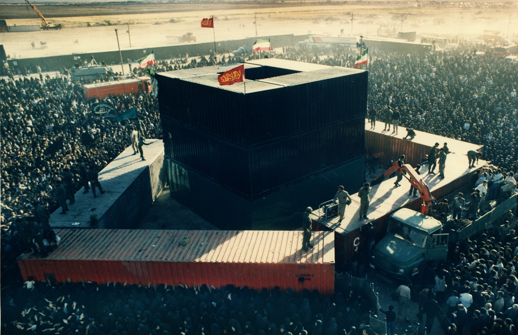 FILE - Mourners crowd around some containers set around the the grave site of the late Ayatollah Khomeini at the cemetery in Beheshte e Zahra, some 70 kms from Tehran, Iran, Sunday June 8, 1989. . (AP Photo/Dusan Vranic, File)