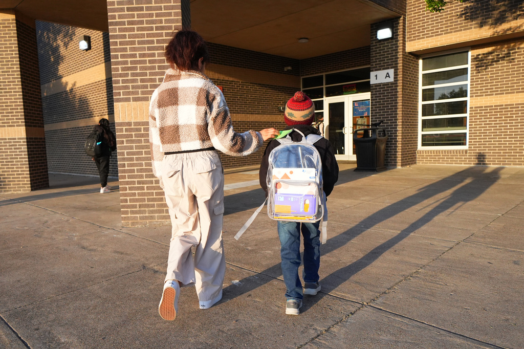 Maria Contreras, left, walks her son, Ian Contreras, to school Thursday, April 9, 2026, in Fort Worth, Texas. (AP Photo/Julio Cortez)