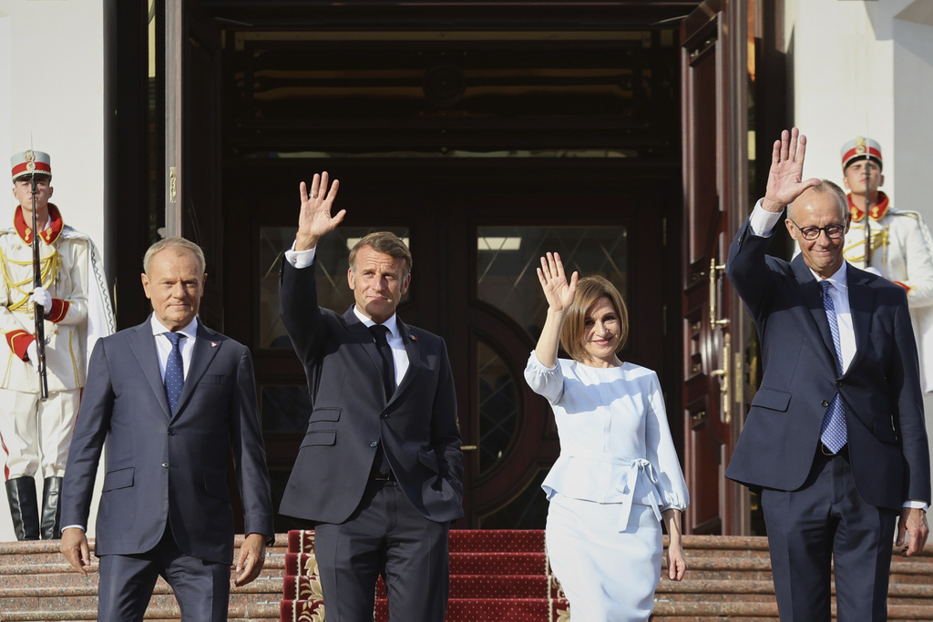 From left, Polish Prime Minister Donald TUsk, French President Emmanuel Macron, Moldova's President Maia Sandu and German Chancellor Friedrich Merz leave the country's presidency headquarters in Chisinau, Moldova, Wednesday, Aug. 27, 2025. (AP Photo/Aurel Obreja)
