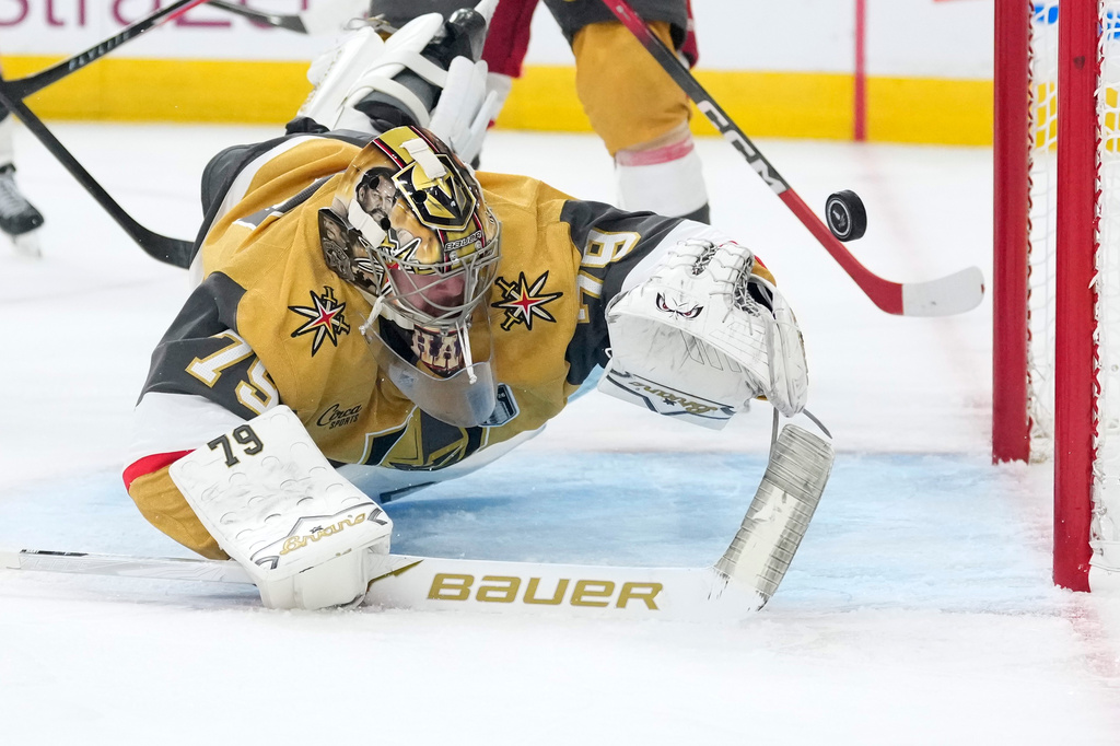 Vegas Golden Knights goaltender Carter Hart is scored on by Carolina Hurricanes center Jordan Staal during the third period in Game 4 of the NHL hockey Stanley Cup Final series Tuesday, June 9, 2026, in Las Vegas. (AP Photo/John Locher)