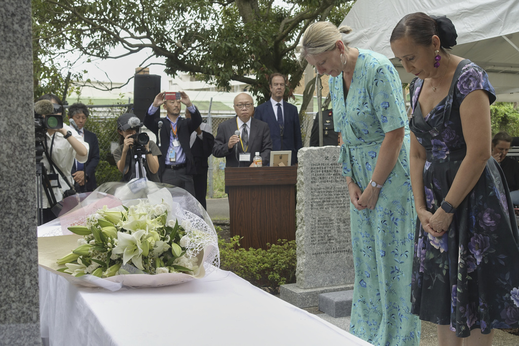 Relatives of former Dutch POWs at a wartime Japanese prison camp in Nagasaki mourn for the victims at the Fukuoka POW Camp No. 2 as they offer flowers at a monument at a former prison site in Koyagi, Nagasaki city, Japan, Saturday, Sept. 13, 2025. (AP Photo/Mari Yamaguchi)