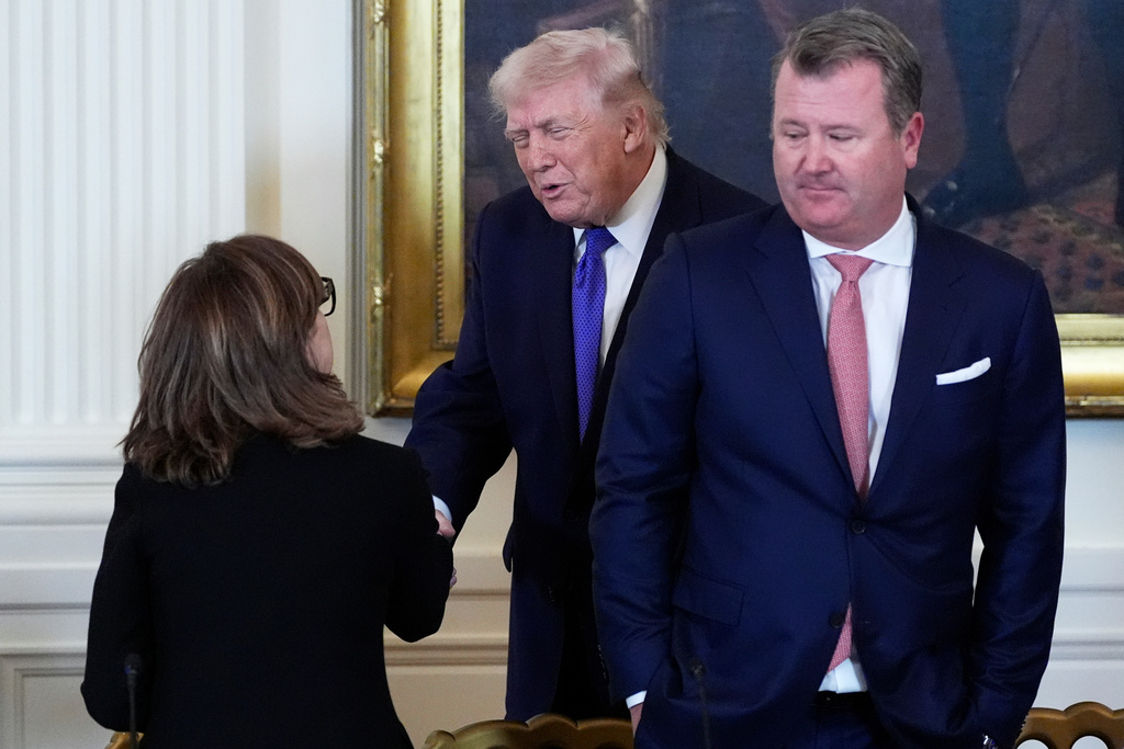President Donald Trump speaks with Chairman, President and Chief Executive Officer of Marathon Petroleum Maryann Mannen, left, while Tallgrass Energy President and Chief Executive Officer Matt Sheehy looks on, right, during a meeting with oil executives in the East Room of the White House, Friday, Jan. 9, 2026, in Washington. (AP Photo/Alex Brandon)