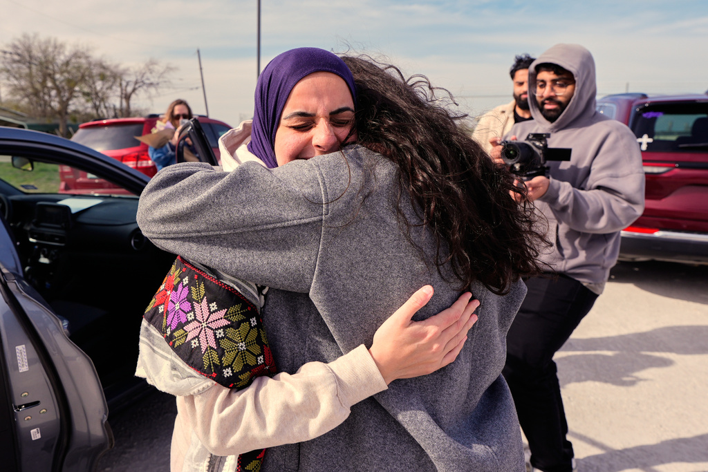 Leqaa Kordia, left, embraces friends, family and suppporters after being released from the Prairieland Detention Center in Alvarado, Texas, Monday, March 16, 2026. (AP Photo/Tony Gutierrez)