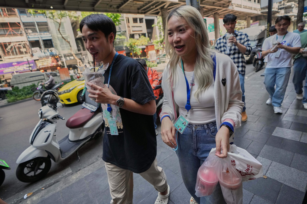 Porwares Tantikanpanit, left, drinks coffee in Bangkok, Thailand, Wednesday, Feb. 11, 2026. (AP Photo/Sakchai Lalit)