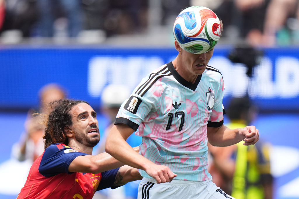 Belgium's Charles De Ketelaere heads the ball flanked by Spain's Marc Cucurella during the World Cup quarterfinal soccer match between Spain and Belgium in Inglewood, Calif., near Los Angeles, Friday, July 10, 2026. (AP Photo/Jae C. Hong)