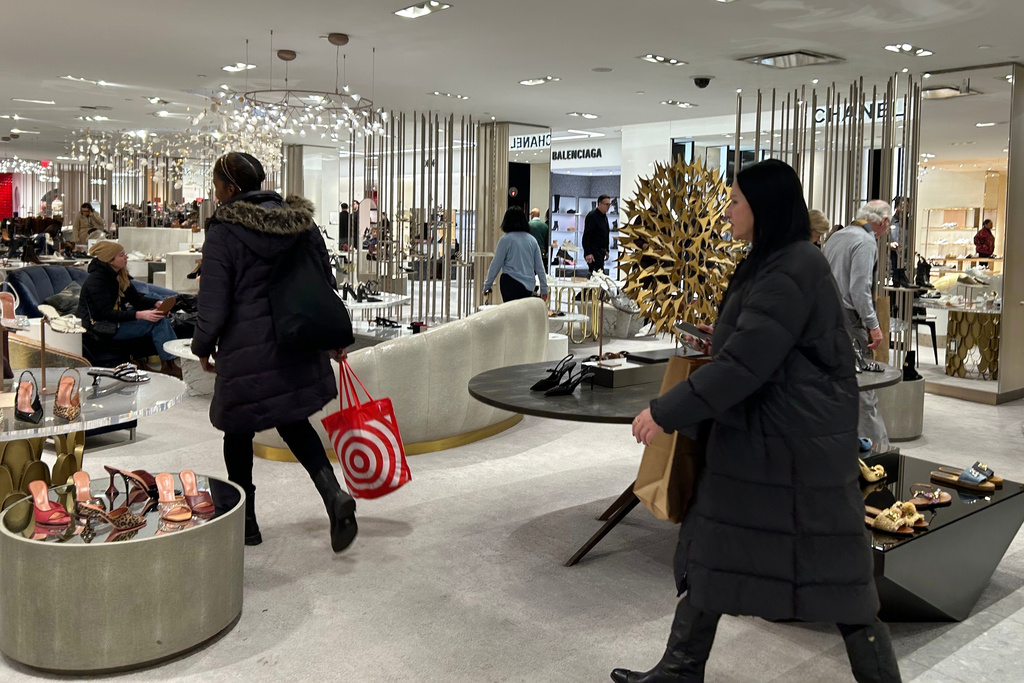 Shoppers walk through Saks Fifth Avenue on Friday, Jan. 16, 2026 in New York. (AP Photo/Anne D'Innocenzio)