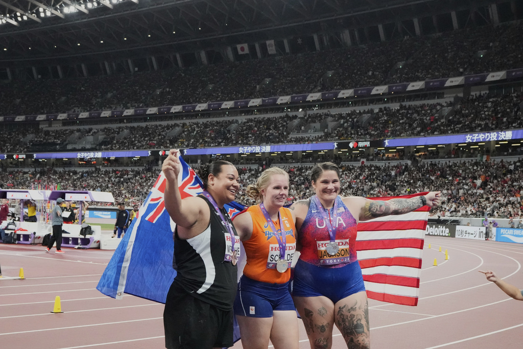 Netherlands' gold medalist Jessica Schilder, center, reacts with United States' silver medalist Chase Jackson, right, and New Zealand's bronze medalist Maddison-Lee Wesche after the women's shot put final at the World Athletics Championships in Tokyo, Saturday, Sept. 20, 2025. (AP Photo/Eugene Hoshiko)