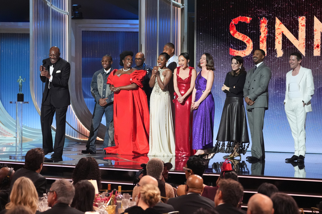 Delroy Lindo, from left, Miles Canton, Wunmi Mosaku, Omar Benson Miller, Jayme Lawson, Li Jun Li, Lola Kirke, Francine Maisler, Michael B. Jordan, and Jack O'Connell accept the award for outstanding performance by a cast in a motion picture for "Sinners" during the 32nd Annual Actor Awards on Sunday, March 1, 2026, at the Shrine Auditorium and Expo Hall in Los Angeles. (AP Photo/Chris Pizzello)