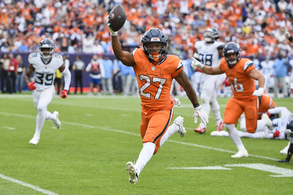 Denver Broncos running back J.K. Dobbins (27) celebrates as he runs the ball for a touchdown during the second half of an NFL football game against the Tennessee Titans, Sunday, Sept. 7, 2025, in Denver. (AP Photo/Eric Lutzen)