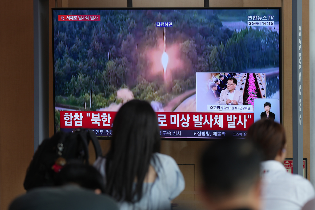 A TV screen shows a reporting of North Korea's unidentified projectile, with file footage during a news program at the Seoul Railway Station in Seoul, South Korea, Tuesday, May 26, 2026. (AP Photo/Lee Jin-man)