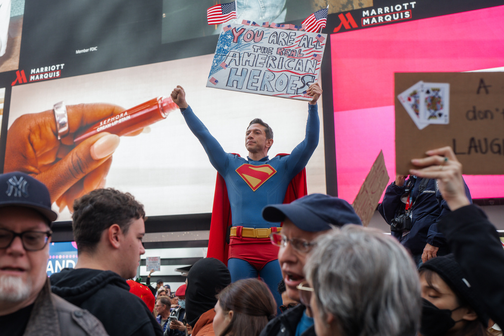 Protester dressed as Superman holds a sign during a "No Kings" protest Saturday, Oct. 18, 2025, in New York. (AP Photo/Olga Fedorova)