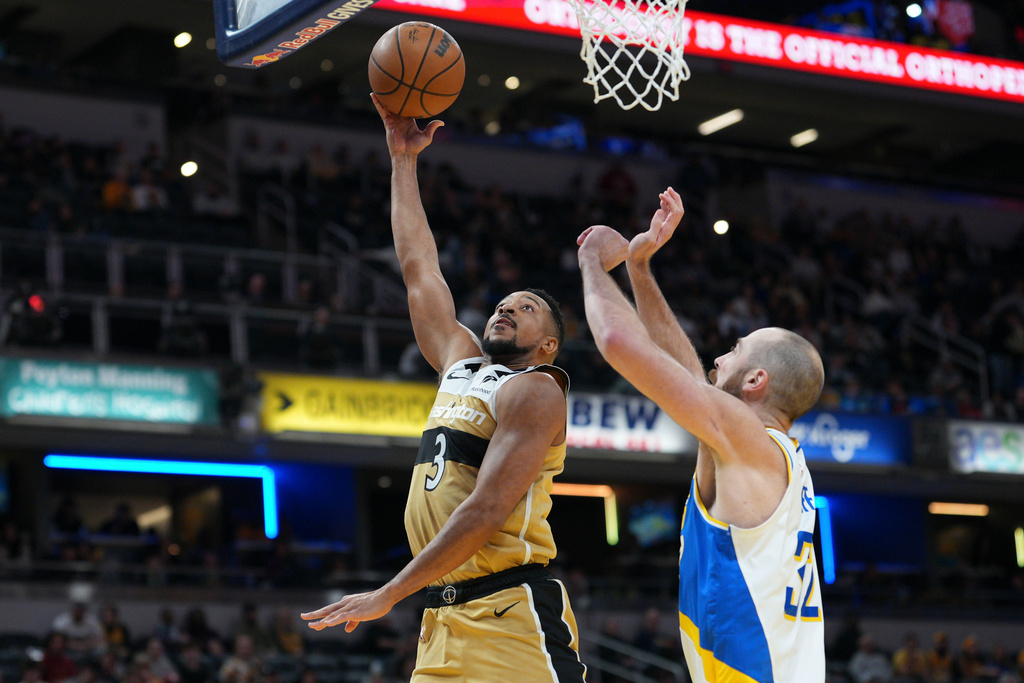Washington Wizards guard CJ McCollum (3) shoot over Indiana Pacers center Jay Huff during the first half of an NBA basketball game in Indianapolis, Sunday, Dec. 14, 2025. (AP Photo/AJ Mast)