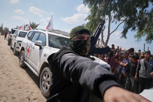 ICRC vehicles carrying released Israeli hostages make their way through groups of Palestinians and Hamas gunmen on their way to the Israeli border, in Khan Younis, southern Gaza Strip, Monday, Oct. 13, 2025. (AP Photo/Jehad Alshrafi) ICRC vehicles carrying released Israeli hostages make their way through groups of Palestinians and Hamas gunmen on their way to the Israeli border, in Khan Younis, southern Gaza Strip, Monday, Oct. 13, 2025. (AP Photo/Jehad Alshrafi)