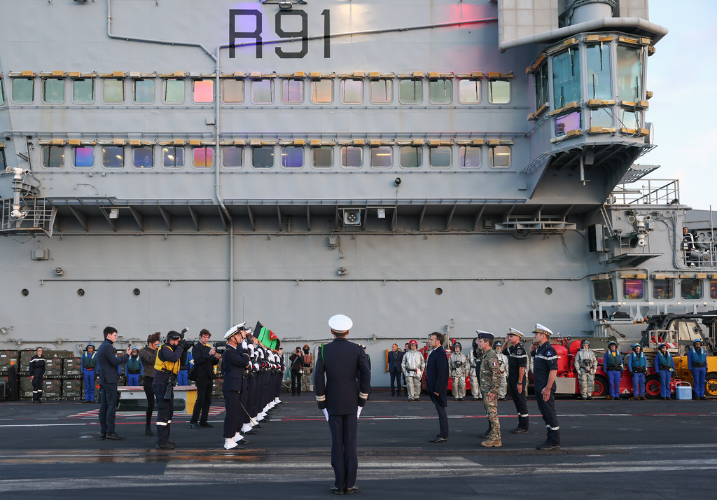 French President Emmanuel Macron, center right, visits the French aircraft carrier Charles de Gaulle, during his visit to Cyprus, Monday March 9, 2026. (Gonzalo Fuentes/Pool Photo via AP)