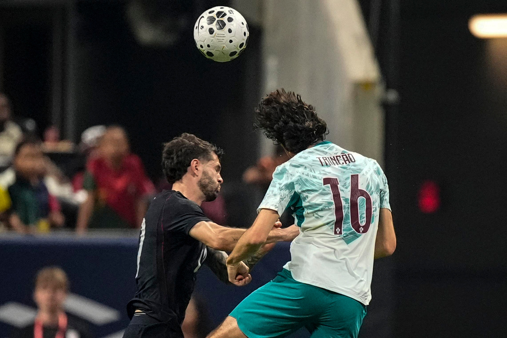 USA's Christian Pulisic (10) and Portugal's Francisco Trincao work during the first half of an international friendly soccer match, Tuesday, March 31, 2026, in Atlanta. (AP Photo/Mike Stewart)
