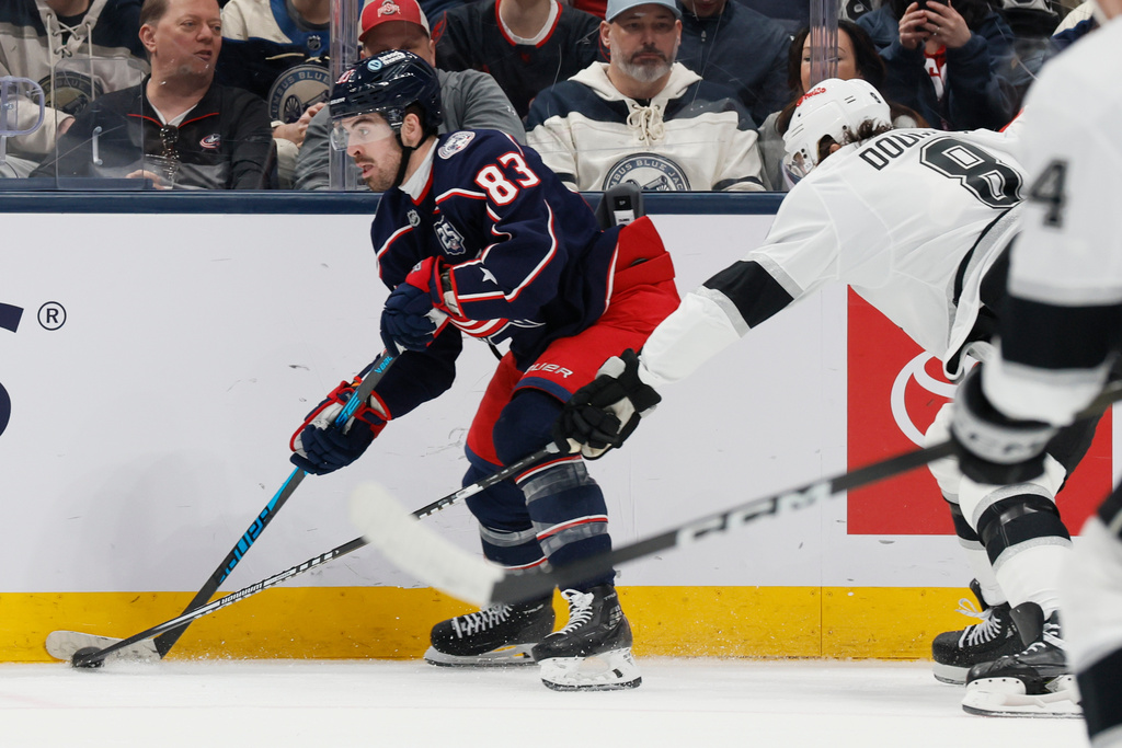 Columbus Blue Jackets' Conor Garland, left, looks for an open pass against Los Angeles Kings' Drew Doughty during the first period of an NHL hockey game, Monday, March 9, 2026, in Columbus, Ohio. (AP Photo/Jay LaPrete)