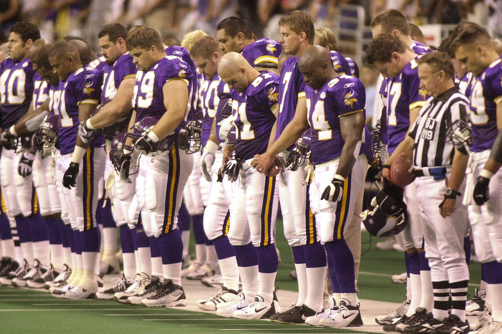 FILE - Minnesota Vikings players stand during a moment of silence for teammate Korey Stringer prior to their preseason game against the New Orleans Saints in San Antonio, Aug. 11, 2001. (AP Photo/Eric Gay, File)