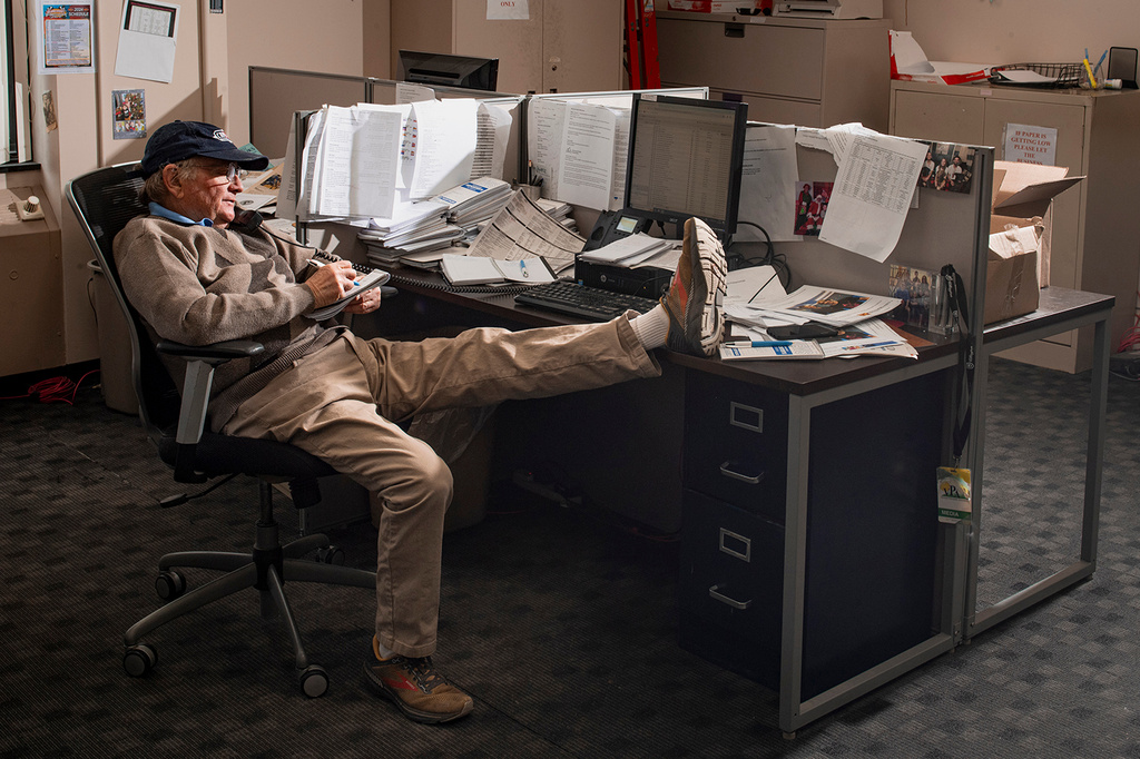 In this photo provided by Ann Hermes, sports reporter Tom Haley takes notes during an interview at his desk in The Rutland Herald newsroom on Feb. 22, 2024, in Rutland, Vermont. (Ann Hermes via AP)