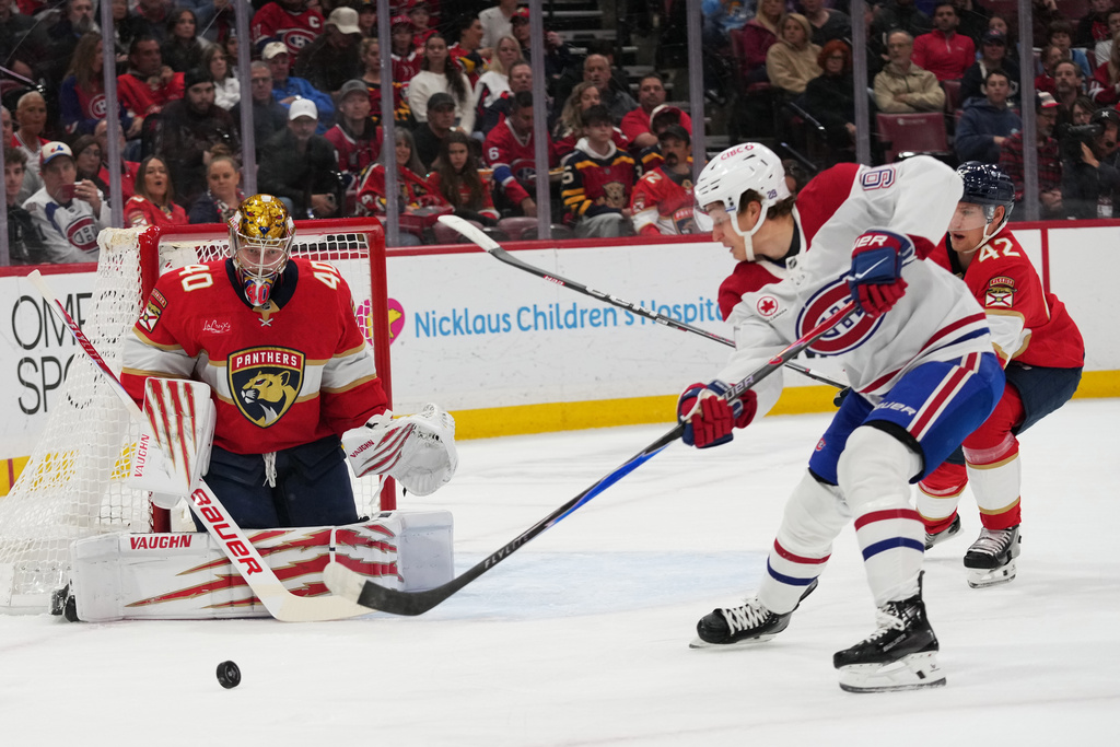 Florida Panthers goaltender Daniil Tarasov (40) defends a shot by Montréal Canadiens center Oliver Kapanen, right, during the first period of an NHL hockey game, Tuesday, Dec. 30, 2025, in Sunrise, Fla. (AP Photo/Lynne Sladky)