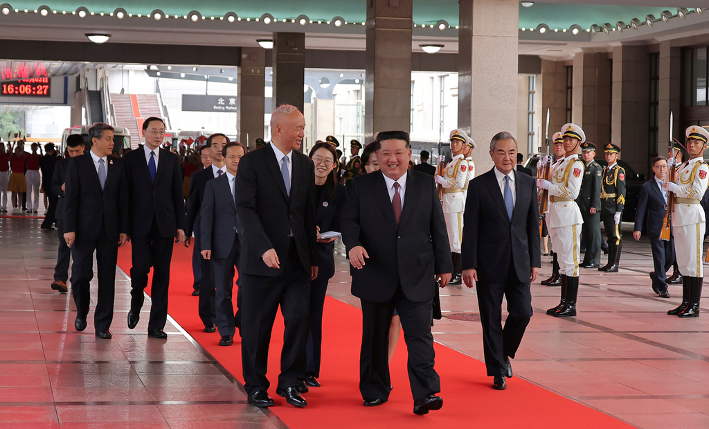 This photo provided by the North Korean government, North Korean leader Kim Jong Un, center, walks with China's Senior Politburo Standing Committee member Cai Qi, center left, and Chinese Foreign Minister Wang Yi, center right, on his arrival at a station in Beijing, China, Tuesday, Sept. 2, 2025. Independent journalists were not given access to cover the event depicted in this image distributed by the North Korean government. The content of this image is as provided and cannot be independently verified. (Korean Central News Agency/Korea News Service via AP)