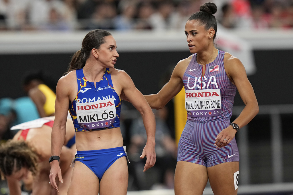 United States' Sydney McLaughlin-Levrone, right, and Romania's Andrea Miklos react after competing in the women's 400 meters semifinal at the World Athletics Championships in Tokyo, Tuesday, Sept. 16, 2025. (AP Photo/Eugene Hoshiko)