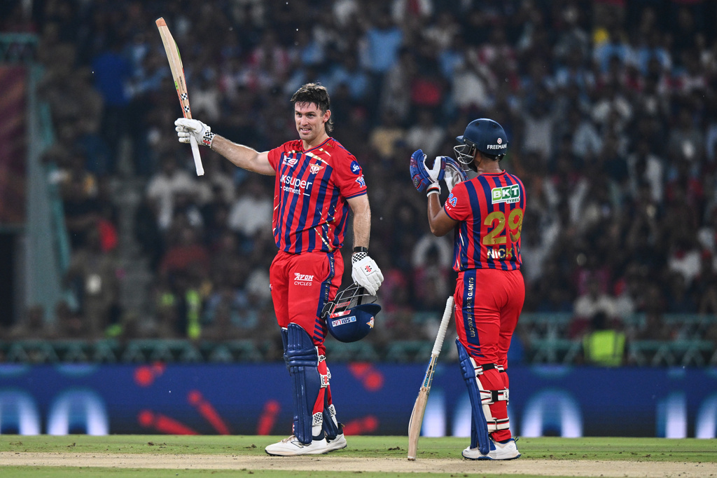 Lucknow Super Giants' Mitchell Marsh, left, celebrates his century with his batting partner Nicholas Pooran during the Indian Premier League cricket match between Royal Challengers Bengaluru and Lucknow Super Giants in Lucknow, India, Thursday, May 7, 2026. (AP Photo)