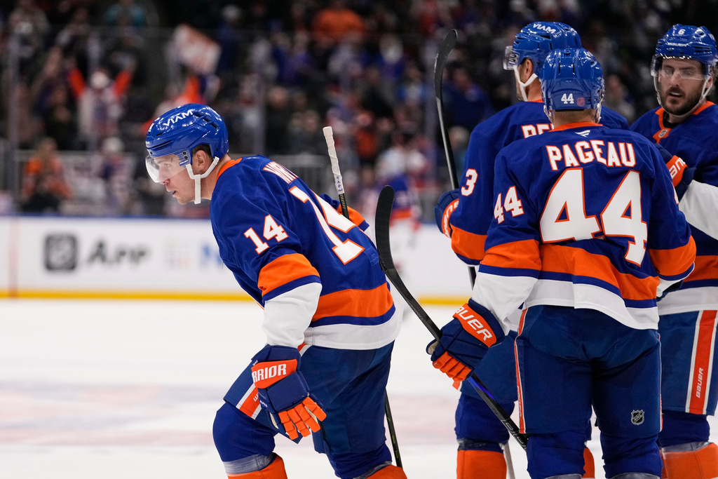 New York Islanders' Bo Horvat (14) celebrates with teammates after scoring a goal during the second period of an NHL hockey game against the Edmonton Oilers Thursday, Oct. 16, 2025, in Elmont, N.Y. (AP Photo/Frank Franklin II)