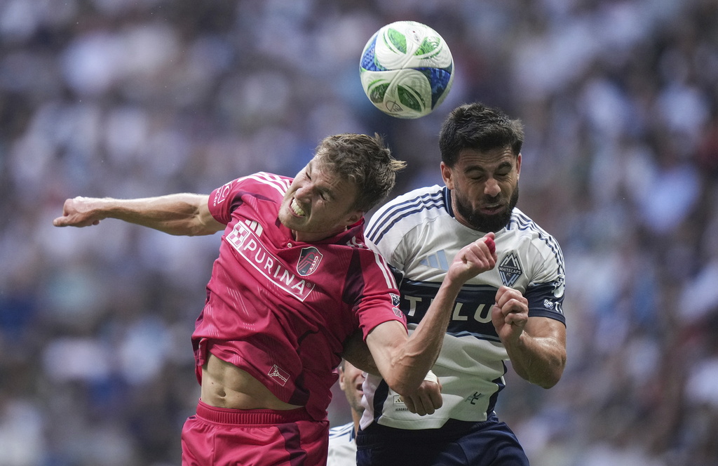St. Louis City's Henry Kessler, left, and Vancouver Whitecaps Brian White vie for the ball during the first half of an MLS soccer match, in Vancouver, on Saturday, August 23, 2025. (Darryl Dyck/The Canadian Press via AP)
