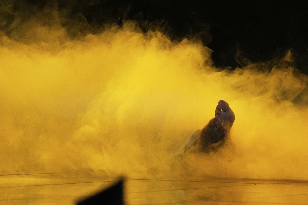 Kazakhstan's Yernar Sadirbayev (Amre) lies in a cloud of smoke as he performs the song "Steppe Light" at the International Music Competition "Intervision" at the Live Arena outside Moscow, Russia, Saturday, Sept. 20, 2025. (AP Photo/Alexander Zemlianichenko)