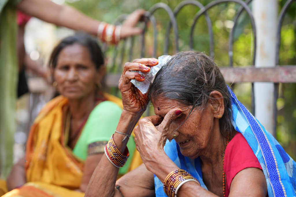 FILE - A woman cools herself off with an ice pack during a heat wave in Banda, northern Indian state of Uttar Pradesh, June 21, 2026. (AP Photo/Rajesh Kumar Singh, File)