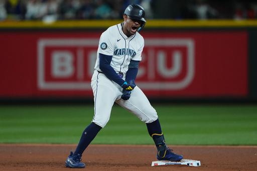 Seattle Mariners' Julio Rodriguez reacts after hitting a double to score Cal Raleigh for the go-ahead run during the eighth inning in Game 2 of baseball's American League Division Series against the Detroit Tigers, Sunday, Oct. 5, 2025, in Seattle. (AP Photo/Lindsey Wasson) Seattle Mariners' Julio Rodriguez reacts after hitting a double to score Cal Raleigh for the go-ahead run during the eighth inning in Game 2 of baseball's American League Division Series against the Detroit Tigers, Sunday, Oct. 5, 2025, in Seattle. (AP Photo/Lindsey Wasson)