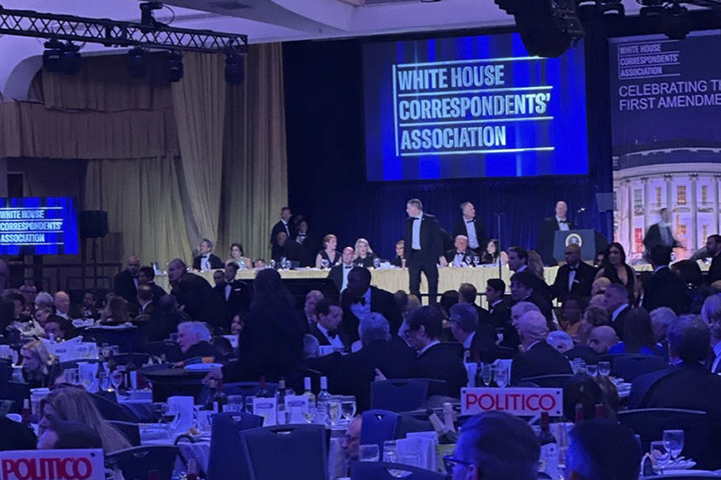 U.S. Secret Service agents respond near President Donald Trump during the White House Correspondents Dinner, Saturday, April 25, 2026, in Washington. (AP Photo/Alex Brandon)