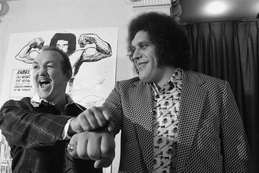 FILE - Heavyweight boxer Chuck Wepner, left, compares fist size with Andre the Giant at a New York news conference on May 4, 1976. (AP Photo/Marty Lederhandler, File)